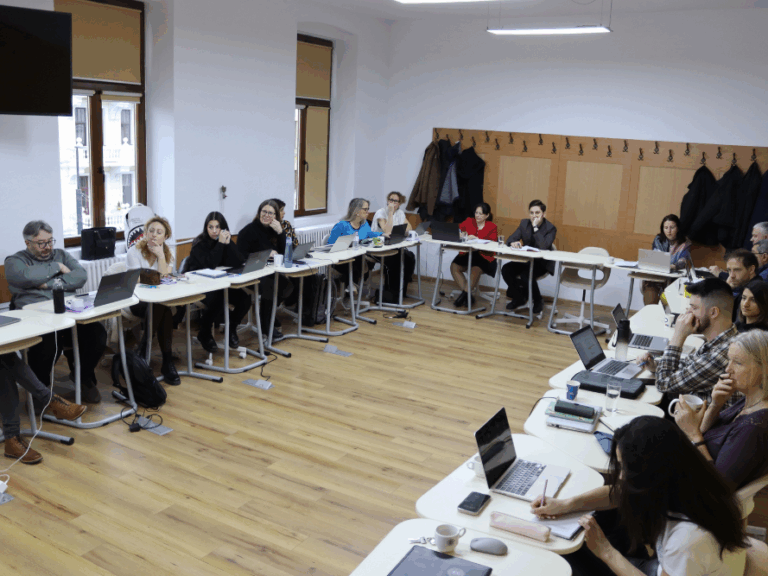 Members of the FUTOURWORK team sat at desks during a meeting