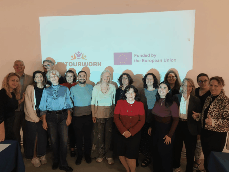 FUTOURWORK team members stand in front of the FUTOURWORK and Funded by the EU logos